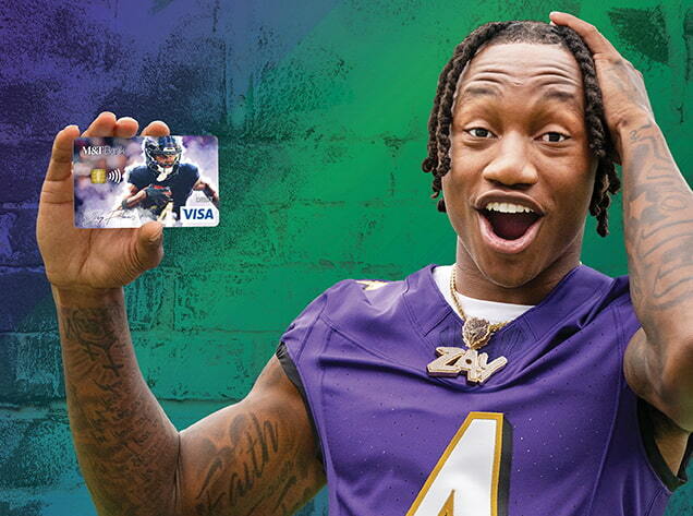 Zay Flowers holding a custom Baltimore Ravens debit card